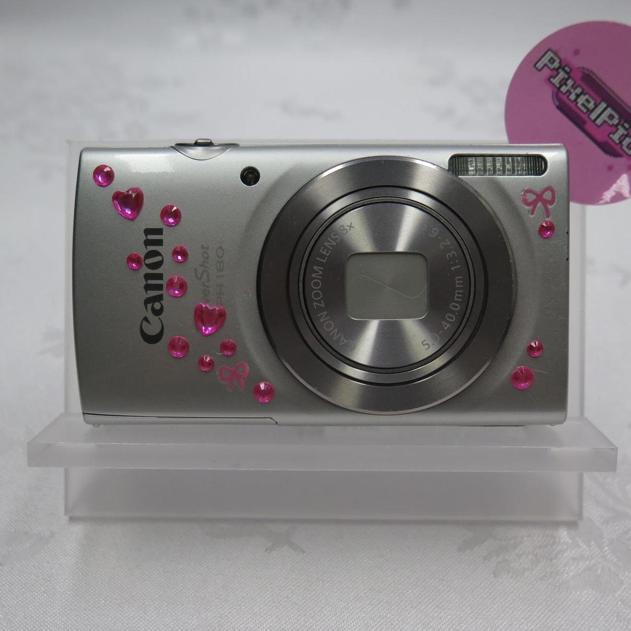 Canon Powershot ELPH 180 ♡𝘾𝙤𝙢𝙚𝙨 𝙬𝙞𝙩𝙝♡ ❥ Camera ❥ Battery ❥ SD card ❥ Charger ❥ SD card reader (if you purchase let me know if you need lightning or usb-c) ❥ Regular hand strap ❥ Beaded hand strap ❥ Case ♡ This cam has been tested extensively to make sure that everything is functional!! We can assure you that every feature has been tested and works perfectly!! ♡ 𐙚 Our shipping days are Tuesday and Thursdays so you should receive your camera 2-7 days after! #DigitalCamera #DigiCam #Camera #Canon #Powershot
